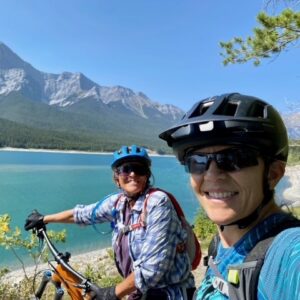 Flow Mountain Bike Adventures coaching in Kananaskis Country, Alberta, Canada. Photo shows two mountain bikers in front of the Spray Lakes
